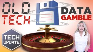 Image of a woman standing next to a large roulette wheel with a floppy disk above it. The text reads "Old Tech," "Data Gamble," and "Tech Update.